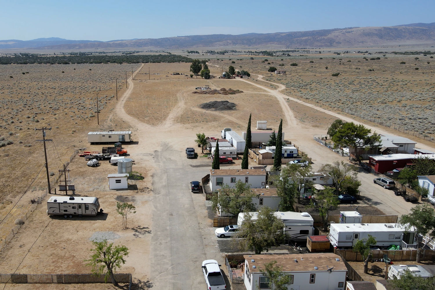 Arial drone view of an RV Park with beautiful desert background.