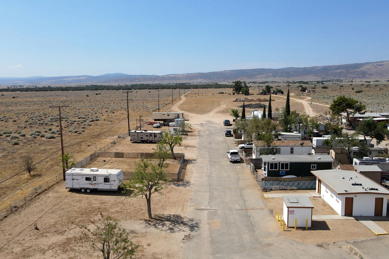 Arial view of the mobile homes with desert and mountain in the background.