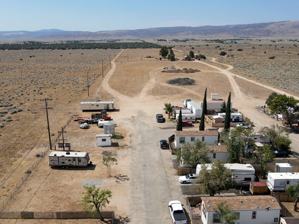 Arial view of the mobile homes with desert and mountain in the background.
