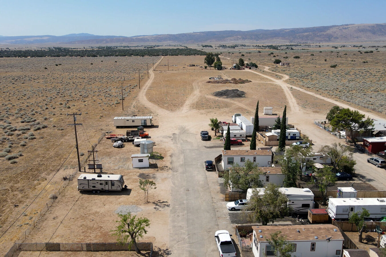 Arial view of the mobile homes with desert and mountain in the background.