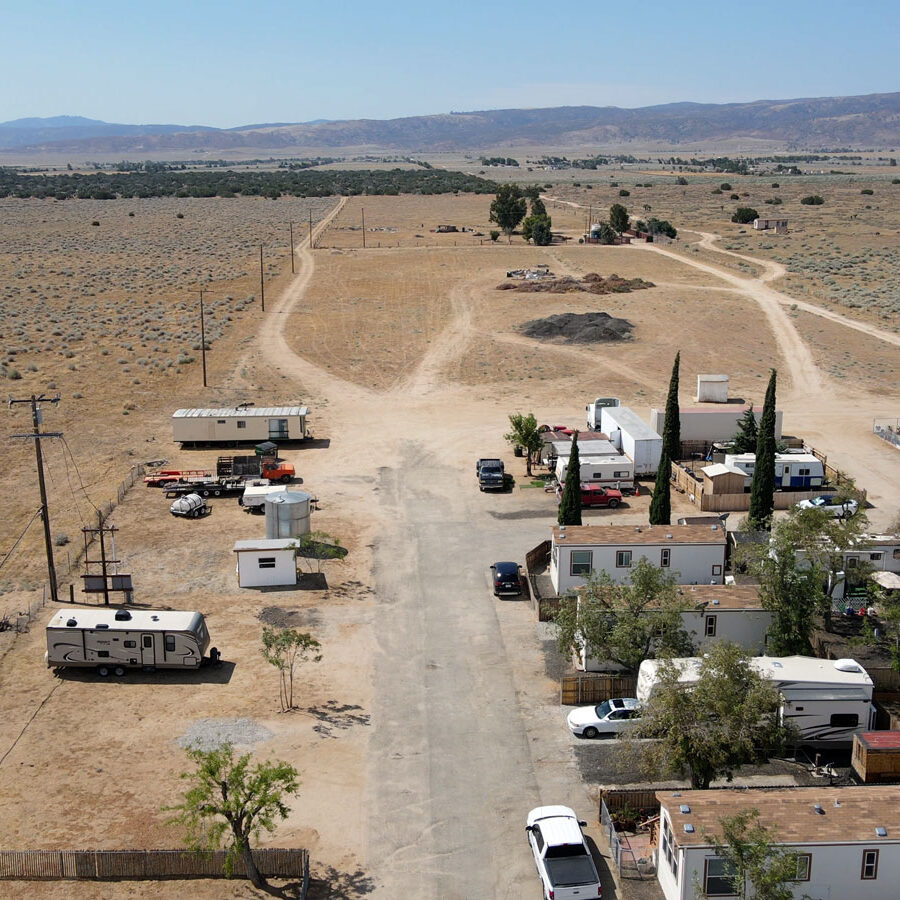 Arial view of the mobile homes with desert and mountain in the background.