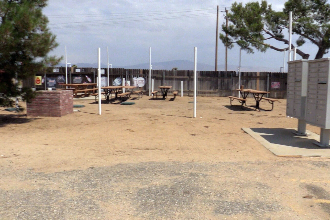 Dirt lot with picnic tables and PO Boxes.