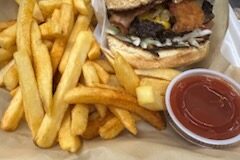 Hamburger with onion and fries.