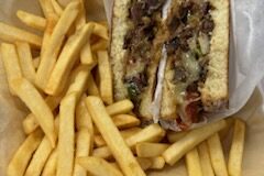 Meat sandwich with fries.