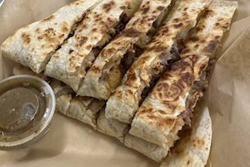 Quesadilla cut up with salsa.